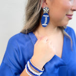 Royal Blue Beaded Football Earrings with a crystal star cluster top on them.