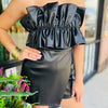 Black faux leather romper with wrap front, strapless, and wide ruffle top. 